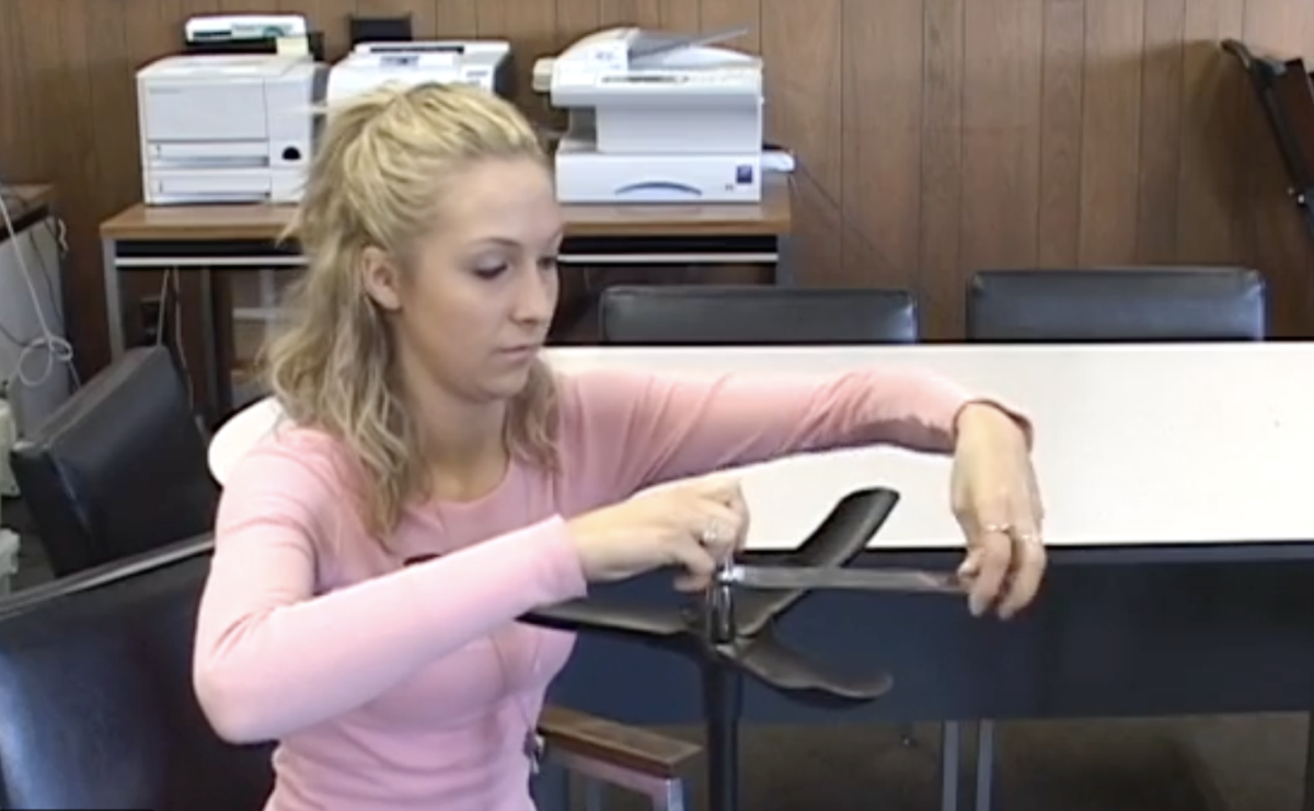 girl fixing music stand that won't tighten2