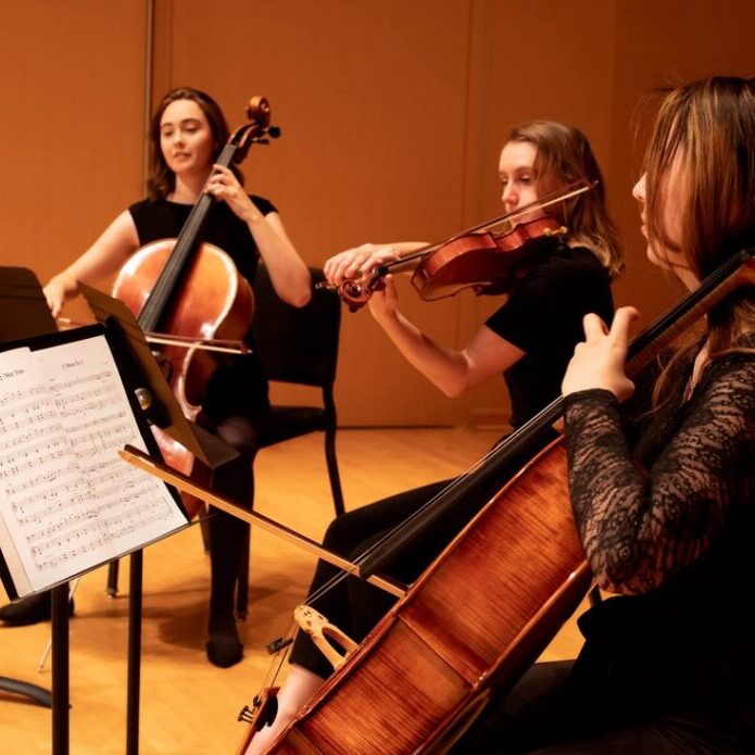 girls playing string instruments